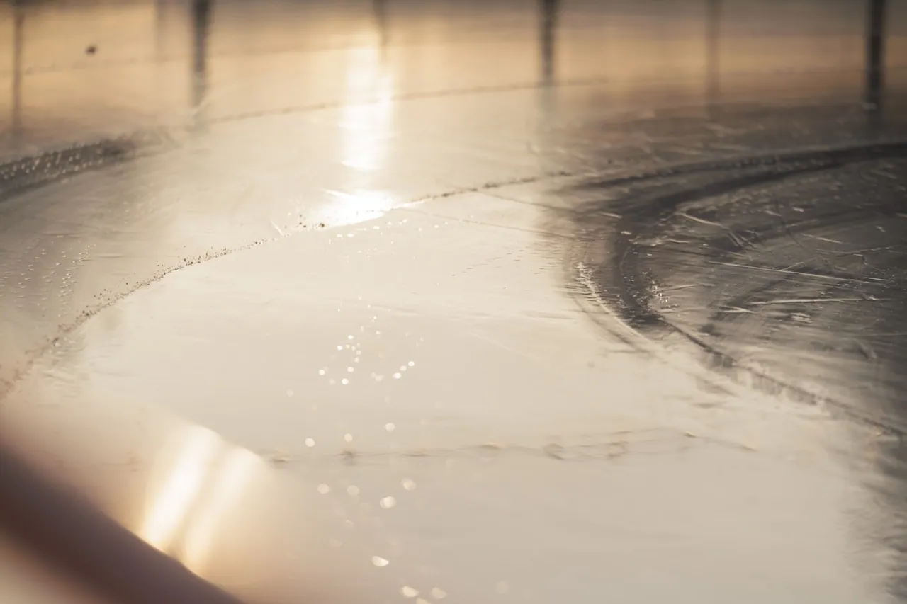Action shot of a soft tonneau cover being washed with a soft brush in proper circular motion, suds on the surface