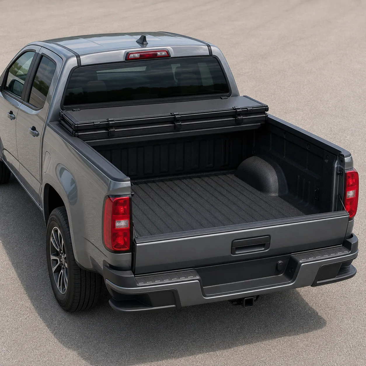Black matte BAKFlip MX4 hard folding tonneau cover folded forward against the cab on a Chevy Colorado bed