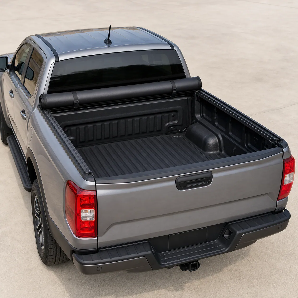 Black TruXedo TruXport soft roll-up tonneau cover rolled forward against the cab of a 2024 Ford Ranger, open bed visible