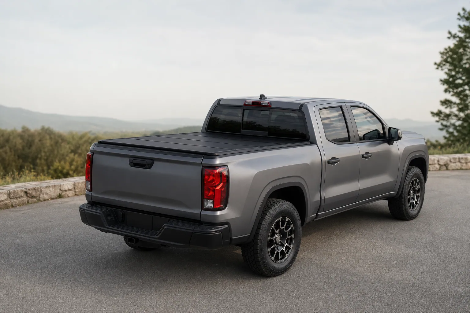 Chevy Colorado with a black hard folding tonneau cover closed over the bed, rear three-quarter view