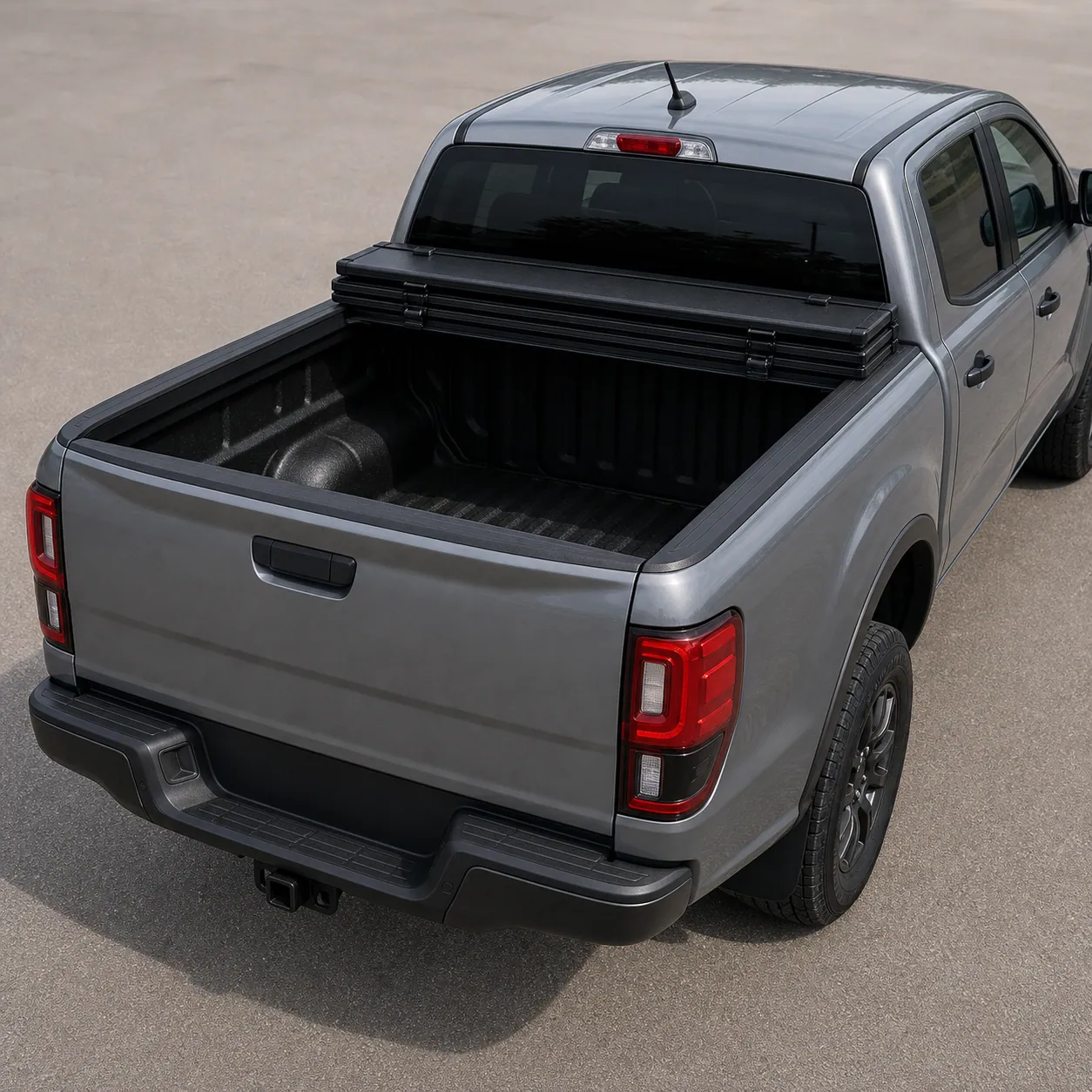 Matte black BAKFlip MX4 hard folding tonneau cover folded forward against the cab on a 2024 Ford Ranger bed
