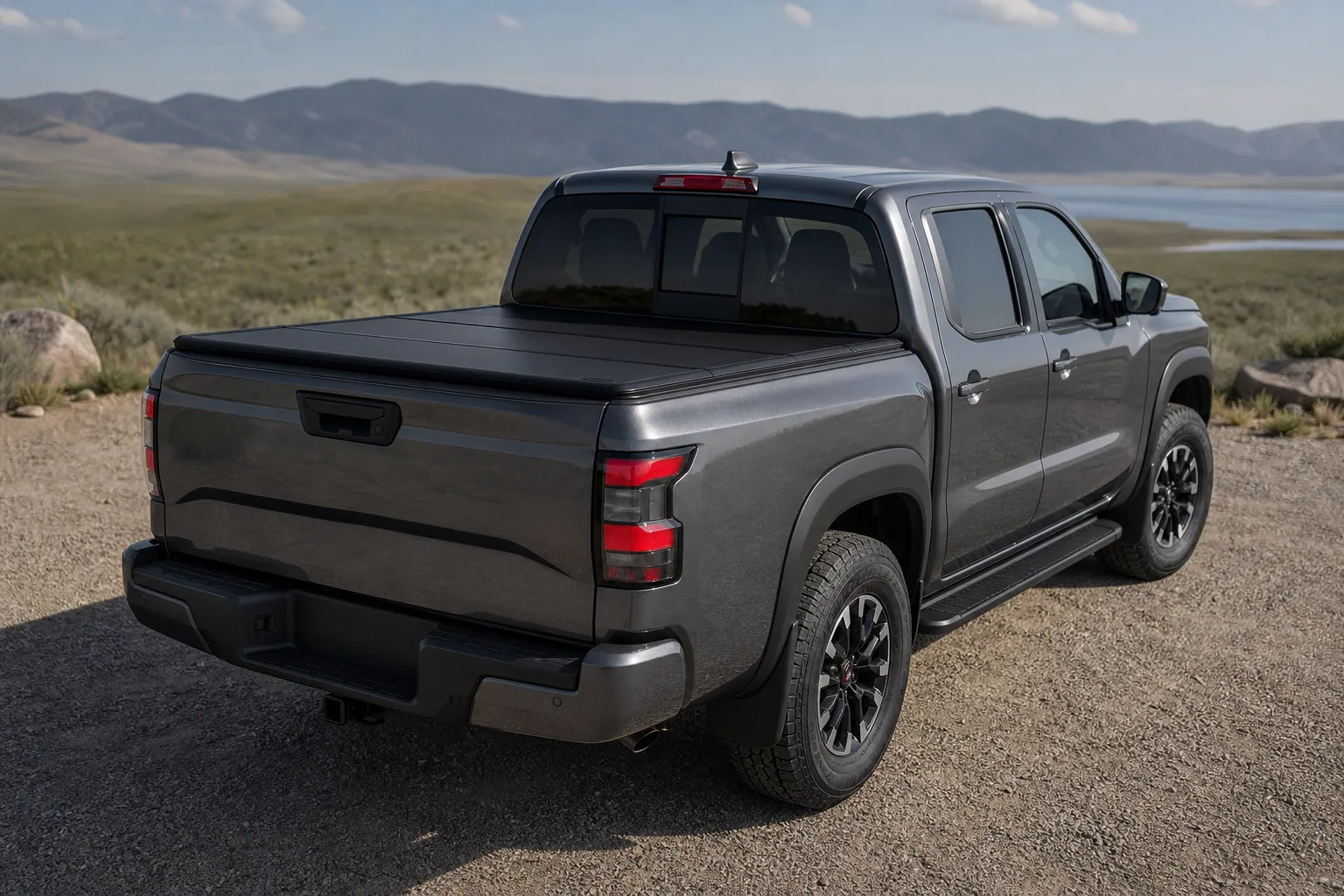 Nissan Frontier Crew Cab with a black hard folding tonneau cover closed over the 5-foot bed