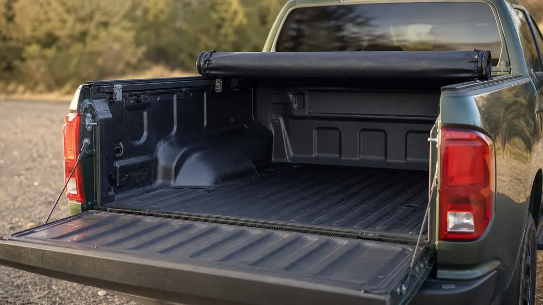 Toyota Tundra bed with the soft roll-up tonneau cover rolled open toward the cab